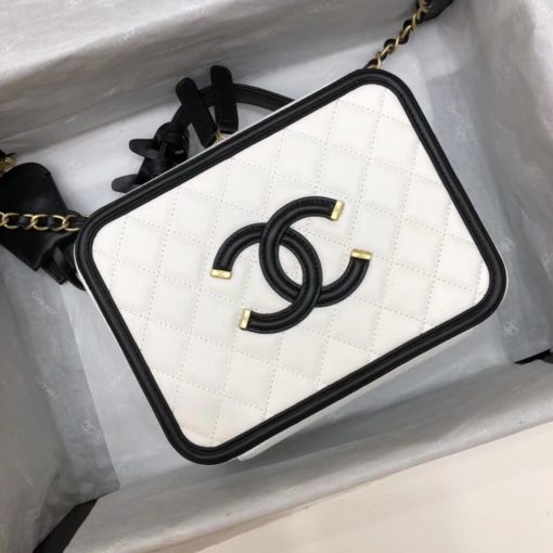 CHANEL Vanity Case Shoulder Bag and Crossbody. Original, authentic quality bag. Genuine Calf Leather. Metal Hardware. Authentic Packaging. Original Quality Dust Bag. Authenticity Card. This iconic CHANEL bag was first released for the Spring-Summer 2016 Collection. Iterations are dropped every new season. This bag is in beautiful grained calfskin leather with brushed metal-tone hardware. It features an embroidered CC stitched logo, a single flat top handle, two hanging clochettes. Its inside is lined with calfskin leather. | CRIS&COCO | High quality designer bags and luxury accessories