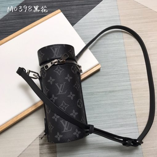 LOUIS VUITTON Bottle Holder. Original Quality Holder including gift box, care book, dust bag, authenticity card. This elegant bottle holder makes the ideal accompaniment for a picnic, an outdoor rendezvous, or playing sports. Embellished with striking Monogram Eclipse canvas, this stylish gift can be used to store small bottles of wine, water, or soda safely. An adjustable strap ensures it can be carried cross-body, over the shoulder, or like a backpack. | CRIS&COCO Authentic Quality Designer Bags and Luxury Accessories