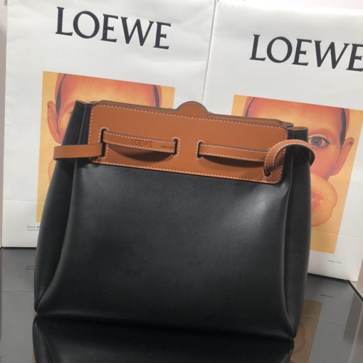 LOEWE Lazo Top Handle Bag. Authentic Quality Bag with literature, gift box, dust bag and authenticity card. A highly chic and sophisticated bag, the Lazo features the recognizable emblematic Gate knot. Contrasting calfskin straps holds the bag, cinching to fasten the bag effortlessly. Creating a sinuous accordion soft silhouette with soft natural calfskin, this novel interpretation is the next must-have chic functional bag of the season. The soft and slouchy calfskin bag is devoid of any zips for the closure and instead relies on the contrasting calfskin straps to cinch and fasten the opening. A relaxed update on a classic bag design. | CRIS&COCO Authentic Quality Designer Bags and Luxury Accessories