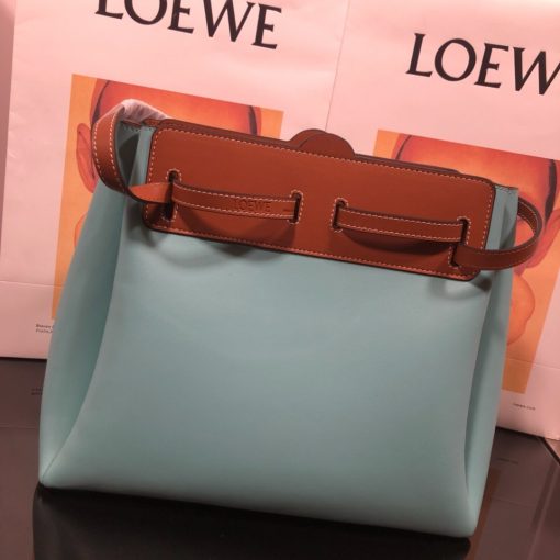 LOEWE Lazo Top Handle Bag. Authentic Quality Bag with literature, gift box, dust bag and authenticity card. A highly chic and sophisticated bag, the Lazo features the recognizable emblematic Gate knot. Contrasting calfskin straps holds the bag, cinching to fasten the bag effortlessly. Creating a sinuous accordion soft silhouette with soft natural calfskin, this novel interpretation is the next must-have chic functional bag of the season. The soft and slouchy calfskin bag is devoid of any zips for the closure and instead relies on the contrasting calfskin straps to cinch and fasten the opening. A relaxed update on a classic bag design. | CRIS&COCO Authentic Quality Designer Bags and Luxury Accessories