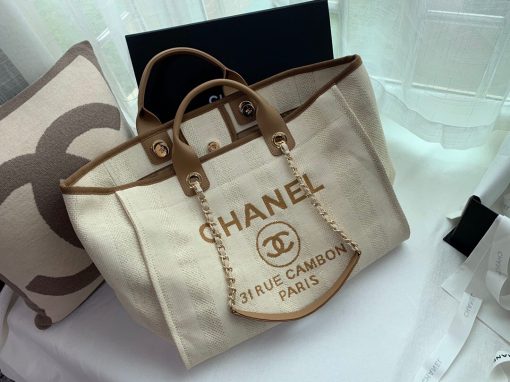 CHANEL Large Deauville Shopping Bag 2021. Authentic quality bag including gift box, booklet, dust bag, authenticity card. The CHANEL Deauville tote matured to a signature CHANEL bag. The bestseller Deauville often appears in seasonal launches in unexpected colors and materials. On the CHANEL website, Chanel calls it the Shopping Bag, but if you walk into a CHANEL boutique and ask for the Deauville, you will be directed to this tote bag. | Cris and Coco Authentic Quality Designer Bags and Luxury Accessories