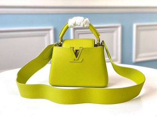 LOUIS VUITTON Capucines Mini. Original Quality Bag including gift box, literature, dust bag, authenticity card. Fashioned from vibrantly colored Taurillon leather, the Capucines Mini handbag pops. The fresh new colorway is perfectly complemented by the discreet metal handle rings. Like all Capucines, the Mini can be carried with the flap out for simple sophistication or tucked inside to feature the LV Initials. | CRIS&COCO Authentic Quality Designer Bag and Luxury Accessories