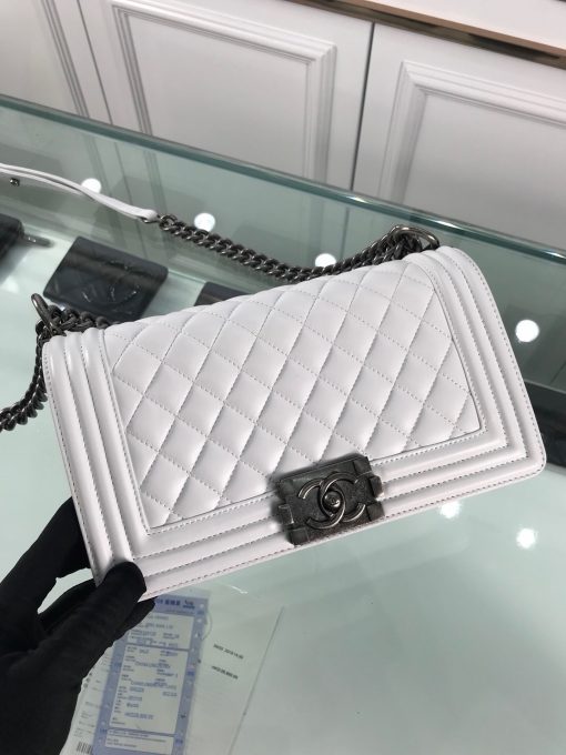 CHANEL Boy Quilted Leather Flap Bag. Original Quality Bag including gift box, literature, dust bag, authenticity card. This stand-out, enviable CHANEL Boy quilted flap bag features a chunky chain-link strap with shoulder pad, CC Boy logo push-lock closure, and antiqued hardware accents. Its push-lock closure opens to a black fabric-lined interior with side zip and slip pockets to secure daily essentials. | Cris and Coco Designer Bags and Accessories