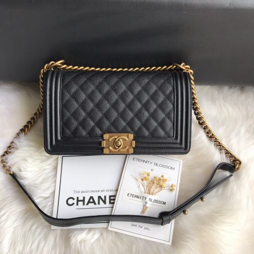 CHANEL Boy Quilted Leather Flap Bag. Original Quality Bag including gift box, literature, dust bag, authenticity card. This stand-out, enviable CHANEL Boy quilted flap bag features a chunky chain-link strap with shoulder pad, CC Boy logo push-lock closure, and antiqued hardware accents. Its push-lock closure opens to a black fabric-lined interior with side zip and slip pockets to secure daily essentials. | Cris and Coco Designer Bags and Accessories