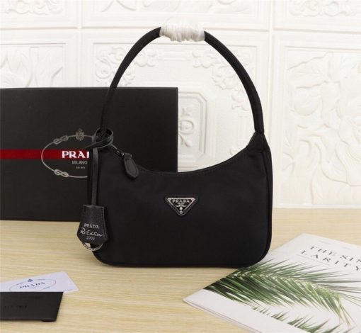 PRADA Re-Edition 2000 Nylon Mini Hobo. High-End Bag including gift box, dust bag, literature, and authenticity card. Practical and feminine, the nylon mini bag is decorated with iconic Saffiano leather trim. It features a contemporary mix of materials. | CRIS and Coco High-End Luxury Accessories