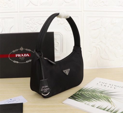 PRADA Re-Edition 2000 Nylon Mini Hobo. High-End Bag including gift box, dust bag, literature, and authenticity card. Practical and feminine, the nylon mini bag is decorated with iconic Saffiano leather trim. It features a contemporary mix of materials. | CRIS and Coco High-End Luxury Accessories