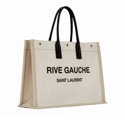 SAINT LAURENT Shopper Leather-Trimmed Printed Canvas Tote. Original Quality Bag including gift box, carebook, dust bag, authenticity card. SAINT LAURENT's 'Shopper' tote is the kind of style we call upon for running errands or weekend market trips. It's made from durable canvas and has soft leather top handles to match the 'Rive Gauche' lettering - it pays homage to the house's original moniker from the '60s. The spacious interior is fitted with a zipped pocket to secure bills and coins. | Cris and Coco Original Quality Designer and Luxury Accessories