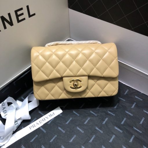 CHANEL Classic New Mini 20 cm Flap Bag. Original Quality Bag including gift box, care book, dust bag, authenticity card. This chic petite shoulder bag is crafted of luxurious shimmery lambskin leather. The crossbody bag features a long chain-link leather threaded shoulder strap and front flap with a CC turn lock. The flap opens to an interior of matching leather with zipper and patch pockets. Enjoy this fabulous bag for everyday essentials or special events with this timeless classic. | CRIS AND COCO High Quality Bags and Luxury Accessories