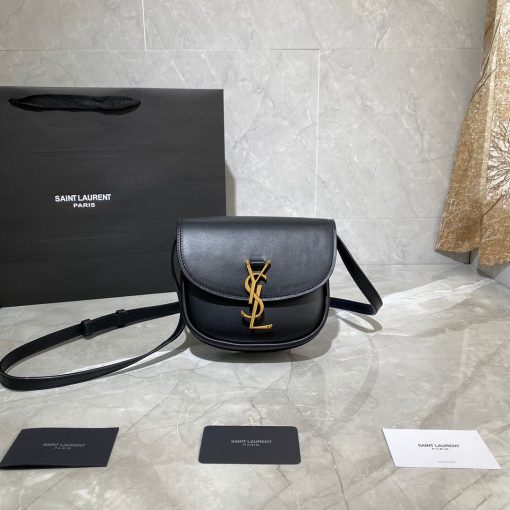 SAINT LAURENT Kaia YSL-Plaque Leather Cross-Body Bag. Original Quality Bag including gift box, care book, dust bag, authenticity card. SAINT LAURENT'S Kaia bag features the label's signature YSL plaque which was sketched by the graphic designer A.M. Cassandre, one of the 20th century's most prominent poster artists. It's crafted from leather to a curved silhouette that's reminiscent of a saddle, then accented by white topstitching. Carry it by the adjustable shoulder strap for contemporary polish. | CRIS and COCO Authentic Quality Designer Bags and Accessories