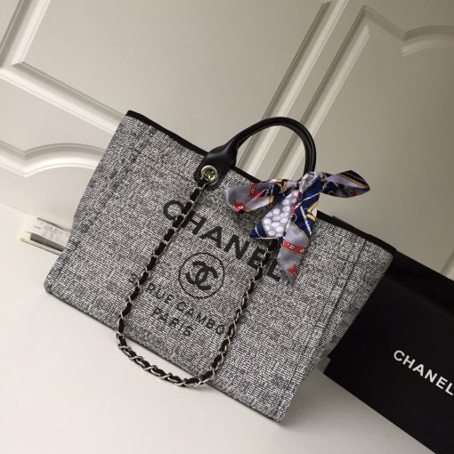 CHANEL Large Deauville Shopping Bag 2021. Authentic quality bag including gift box, booklet, dust bag, authenticity card. The CHANEL Deauville tote matured to a signature CHANEL bag. The bestseller Deauville often appears in seasonal launches in unexpected colors and materials. On the CHANEL website, Chanel calls it the Shopping Bag, but if you walk into a CHANEL boutique and ask for the Deauville, you will be directed to this tote bag. | Cris and Coco Authentic Quality Designer Bags and Luxury Accessories