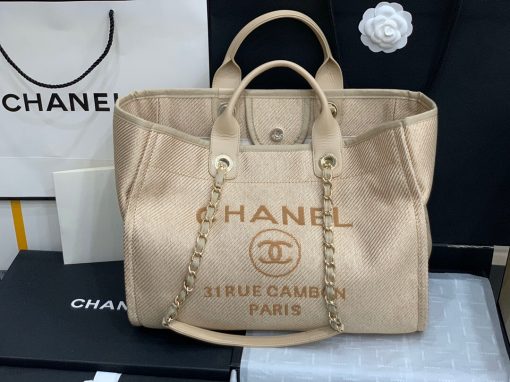 CHANEL Large Deauville Shopping Bag 2021. Authentic quality bag including gift box, booklet, dust bag, authenticity card. The CHANEL Deauville tote matured to a signature CHANEL bag. The bestseller Deauville often appears in seasonal launches in unexpected colors and materials. On the CHANEL website, Chanel calls it the Shopping Bag, but if you walk into a CHANEL boutique and ask for the Deauville, you will be directed to this tote bag. | Cris and Coco Authentic Quality Designer Bags and Luxury Accessories