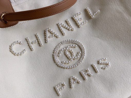 CHANEL Large Deauville Shopping Bag 2021. Authentic quality bag including gift box, booklet, dust bag, authenticity card. The CHANEL Deauville tote matured to a signature CHANEL bag. The bestseller Deauville often appears in seasonal launches in unexpected colors and materials. On the CHANEL website, Chanel calls it the Shopping Bag, but if you walk into a CHANEL boutique and ask for the Deauville, you will be directed to this tote bag. | Cris and Coco Authentic Quality Designer Bags and Luxury Accessories