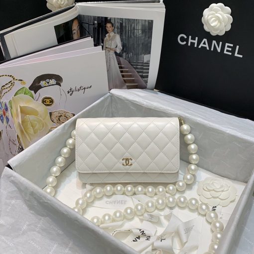 CHANEL Mini Wallet On Chain With Imitation Pearls. Original Quality Wallet including gift box, care book, dust bag, authenticity card. This CHANEL Mini Wallet On Chain With Imitation Pearl comes with an oversized pearl strap. It’s like a dream that comes true. There are so many pearls that keep our heart-melting. And also they’re extremely large pearls as well. | CRIS&COCO Authentic Quality Designer Bags and Luxury Accessories