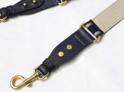 DIOR Christian Dior Shoulder Strap. Original Quality Strap including gift box, care book, dust bag, authenticity card. The 'Christian Dior' signature is featured at the center of the slender shape, framed by black calfskin on either side. Two antique gold-finish metal snap hooks attach the strap to the bag of choice. The strap may be worn over the shoulder or crossbody for a highly personalized style. | CRIS&COCO Authentic Quality Designer Bags and Luxury Accessories