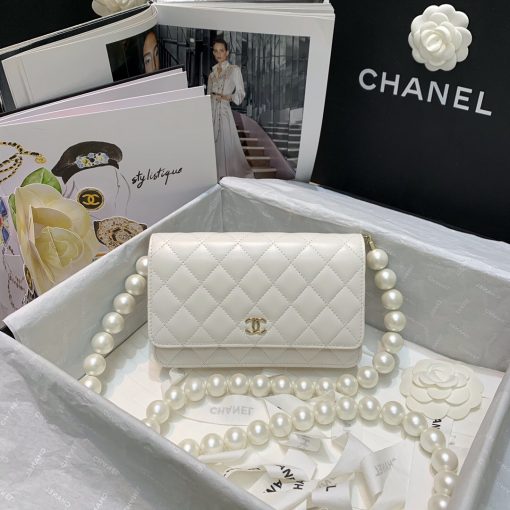 Chanel Wallet on Chain (WOC) Pearls. Original Quality Bag including gift box, care book, dust bag, authenticity card. This style is part of Chanel’s Fall/Winter 2020 Collection. The classic lambskin wallet on chain gets a chic new update with a strap adorned with imitation pearls. It is available in the regular size. The pearl strap is one of the most popular designs from the collection. Chanel’s iconic pearls brings in an elegant touch on the casual WOC. It can be worn as an everyday bag or used as an evening bag. | CRIS&COCO Authentic Quality Designer Bags and Luxury Accessories