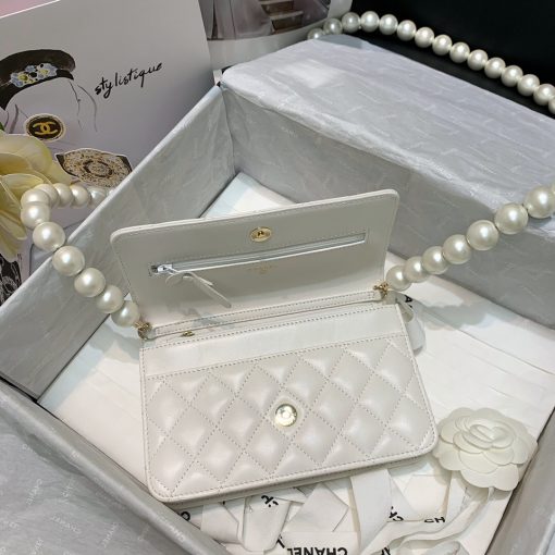 Chanel Wallet on Chain (WOC) Pearls. Original Quality Bag including gift box, care book, dust bag, authenticity card. This style is part of Chanel’s Fall/Winter 2020 Collection. The classic lambskin wallet on chain gets a chic new update with a strap adorned with imitation pearls. It is available in the regular size. The pearl strap is one of the most popular designs from the collection. Chanel’s iconic pearls brings in an elegant touch on the casual WOC. It can be worn as an everyday bag or used as an evening bag. | CRIS&COCO Authentic Quality Designer Bags and Luxury Accessories