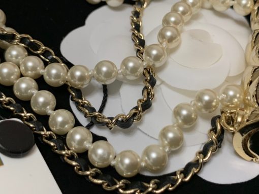 CHANEL Long Necklace. This CHANEL Long Necklace- Gold, Black & Pearly White is part of the Spring-Summer 2021 fashion collection. The artistry and craftsmanship of the House of CHANEL.| CRIS&COCO Authentic Quality Designer Bags and Luxury Accessories