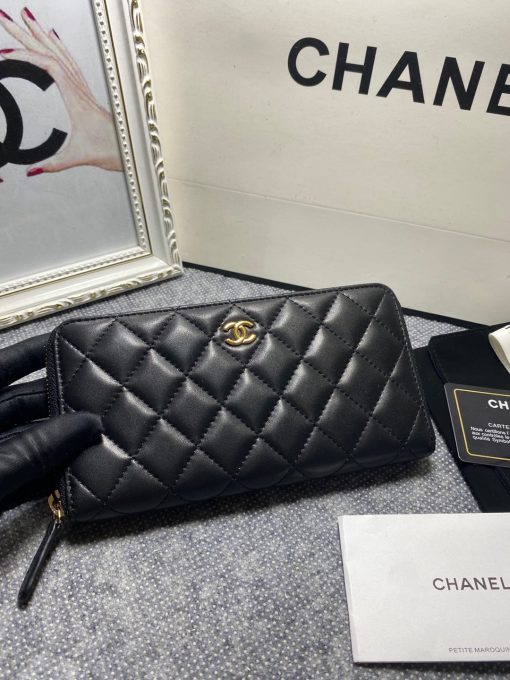 CHANEL Classic Long Zipped Wallet.  Original Quality Wallet including gift box, care book, dust bag, authenticity card. This wallet is one of the signature wallets of Chanel. It has been around for some time now and it will continue to stick around. This wallet is practical and amazing; perfect to hold paper money, credit cards and coins. The classic black color, you will get the signature burgundy colored interior. | CRIS&COCO Authentic Quality Designer Bags and Luxury Accessories