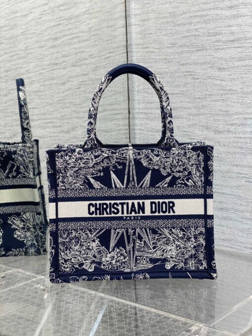 DIOR Book Tote. Original Quality Bag including gift box, care book, dust bag, authenticity card. This Book Tote is an original style introduced by Creative Director Maria Grazia Chiuri. This has become a staple of the Dior aesthetic. Ideally designed to carry all your daily essentials, the small shape is fully embroidered and the 'Christian Dior' signature on the front. This carryall is a perfect example of the Dior savoir-faire and also may be coordinated with a pouch or other small leather goods for a complete look. | CRIS&COCO Authentic Quality Designer Bags and Luxury Accessories