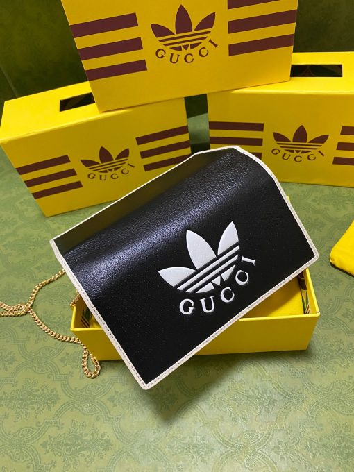 GUCCI X ADIDAS Wallet With Chain.  Original Quality Wallet including gift box, care book, dust bag, authenticity card. Part of the GUCCI X ADIDAS collection, this chain wallet features the Gucci Trefoil print. Emblematic House’s motifs mix with those of the historic sportswear brand adidas. The collection sees both heritages encoded in a trio of lines, where adidas and Gucci combine archival emblems. Creative Director, Alessandro Michele pulls inspiration from his memories of the ‘80s and ‘90s for a collection that is both nostalgia-driven and contemporary. | CRIS&COCO Authentic Quality Designer Bag and Luxury Accessories