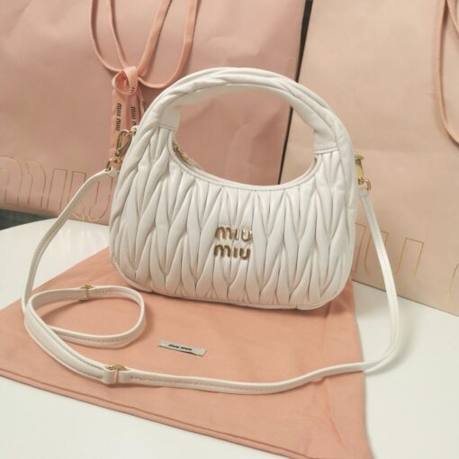 MIU MIU Wander Matelassé Mini Hobo Bag. Original Quality Bag including gift box, care book, dust bag, authenticity card. The Miu Wander bag is reinterpreted season after season, becoming an iconic accessory of Miu Miu collections. Made of matelassé nappa leather, the bag is characterized by the sophisticated, three-dimensional effect created by the refined workmanship. The hobo shape, blending retro inspirations and contemporary elegance, becomes a new synonym of modern femininity. | CRIS&COCO Authentic Quality Designer Bag and Luxury Accessories