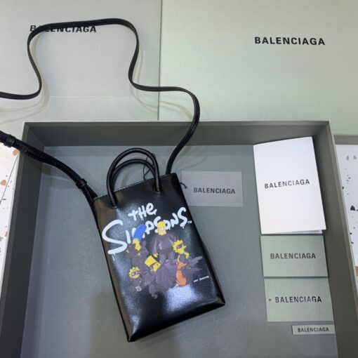 BALENCIAGA Mini Shopping Bag. Original Quality Bag including gift box, care book, dust bag, authenticity card. A new season may be here, but the frenzy for logomania is far from over. At the helm of the trend, Balenciaga continues to offer branded styles. Case in point: this mini shopping bag. Featuring round top handles, a shoulder strap, a strap closure, a main internal compartment and a printed logo to the front. | CRIS&COCO Authentic Quality Designer Bags and Luxury Accessories