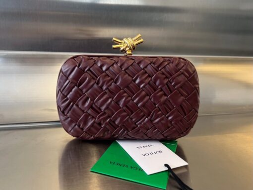 BOTTEGA VENETA Knot Clutch. Original Quality Bag including gift box, care book, dust bag, authenticity card. Bottega Veneta's intrecciato technique has rapidly become a signature style code of the Italian brand since its founding in 1966, amassing fans from across the globe. This leather clutch features a contemporary update in the form of a knot. Wear yours with vibrant outfits. | CRIS&COCO Authentic Quality Designer Bags and Luxury Accessories