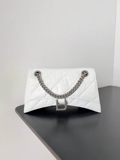 BALENCIAGA Crush Small Chain Bag. Original Quality Bag including gift box, care book, dust bag, authenticity card. Crush on this metallic Crush Chain Bag. This is a new iteration on their celebrated curvilinear design, complete with tonal B logo hardware and shoulder and crossbody chain. Crafted in a contemporary crushed quilted calfskin. | CRIS&COCO Authentic Quality Designer Bags and Luxury Accessories