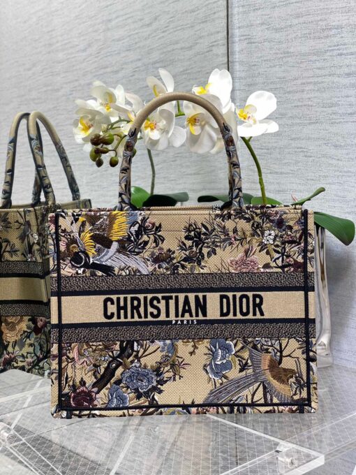 DIOR Small Book Tote. Original Quality Bag including gift box, care book, dust bag, authenticity card. This DIOR Tote is an original creation introduced by Dior's Creative Director, Maria Grazia Chiuri, and has become a staple of the Dior aesthetic. Designed to hold all the daily essentials, it is fully embroidered. Adorned with a Christian Dior Paris signature on the front, the small tote exemplifies the House's signature savoir-faire and may be carried by hand. | CRIS&COCO Authentic Quality Designer Bags and Luxury Accessories