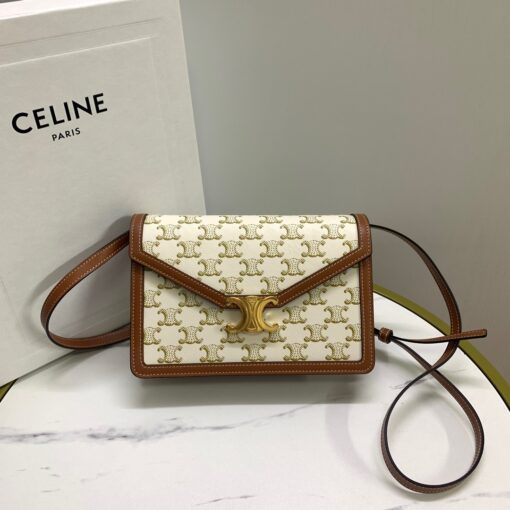 CELINE Wallet On Chain Triomphe. Original Quality Bag including gift box, care book, dust bag, authenticity card. Looking for a reasonable priced high fashion WOC. Take a look at this latest Celine Wallet On Chain from the Spring Summer 2021 Collection. Made from calfskin, this WOC is made for flaunting. The center comes with the famous Triomphe CC logo. There are different colors available, but the bag comes with a chain colored in gold hardware. The chain can also be removed so you can turn it into an evening clutch. You also get a shoulder pad. | CRIS&COCO Authentic Quality Designer Bags and Luxury Accessories