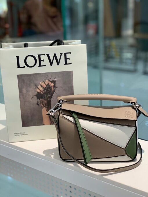 LOEWE Mini Puzzle Bag. Original Quality Bag including gift box, care book, dust bag, authenticity card. The Puzzle bag is the debut bag for LOEWE by Creative Director Jonathan Anderson. A cuboid shape and precise cutting technique create Puzzle’s distinctive geometric lines. This mini version is crafted in contrasting calfskins. | CRIS AND COCO Authentic Quality Luxury Accessories