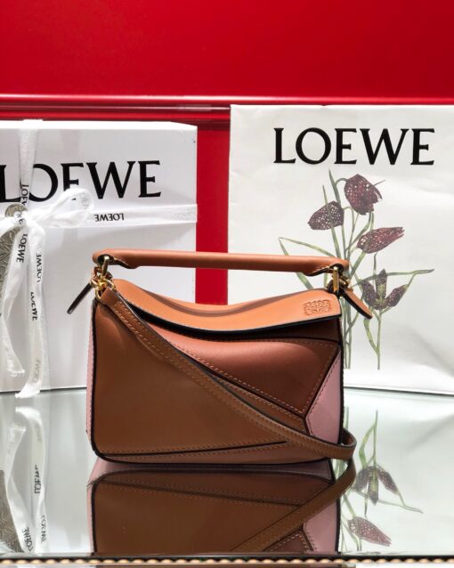 LOEWE Mini Puzzle Bag. Original Quality Bag including gift box, care book, dust bag, authenticity card. The Puzzle bag is the debut bag for LOEWE by Creative Director Jonathan Anderson. A cuboid shape and precise cutting technique create Puzzle’s distinctive geometric lines. This mini version is crafted in contrasting calfskins. | CRIS AND COCO Authentic Quality Luxury Accessories