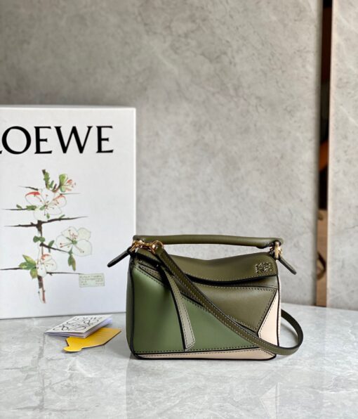 LOEWE Mini Puzzle Bag. Original Quality Bag including gift box, care book, dust bag, authenticity card. The Puzzle bag is the debut bag for LOEWE by Creative Director Jonathan Anderson. A cuboid shape and precise cutting technique create Puzzle’s distinctive geometric lines. This mini version is crafted in contrasting calfskins. | CRIS AND COCO Authentic Quality Luxury Accessories