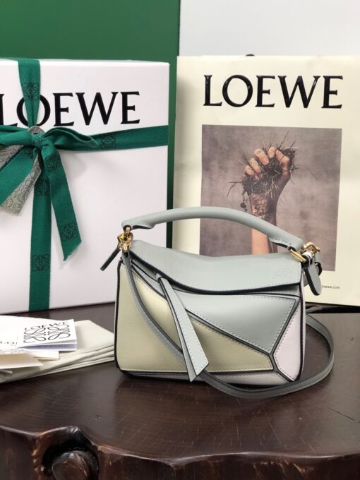 LOEWE Mini Puzzle Bag. Original Quality Bag including gift box, care book, dust bag, authenticity card. The Puzzle bag is the debut bag for LOEWE by Creative Director Jonathan Anderson. A cuboid shape and precise cutting technique create Puzzle’s distinctive geometric lines. This mini version is crafted in contrasting calfskins. | CRIS AND COCO Authentic Quality Luxury Accessories