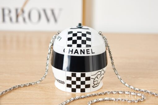 CHANEL Helmet Minaudiere. High-End Quality Bag including gift box, care book, dust bag, authenticity card. This precious creation was unveiled along with the Slot Machine Minaudière and Sphere Minaudière at #CHANELCruise 2023. The 11 cm by 10 cm objet d’art sees diamanté crystals and Chanel logos peppering the full resin exterior for maximum effect. Capturing attention in eye-catching black, red and white, it is equal parts clutch and eye candy. | CRIS AND COCO Authentic Quality Luxury Accessories