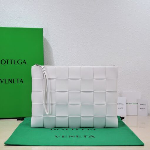 BOTTEGA VENETA Large Intreccio Leather Pouch.  High-End Quality Bag including gift box, care book, dust bag, authenticity card. This stylish zipped pouch from Bottega Veneta is a handy accessory to have. It is expertly crafted from a luxurious leather featuring the signature Intreccio weave. It features a removable wristlet so you can carry it however you desire. It also has a smooth leather interior lining which adds to its fine quality. It closes with a reliable metal zipper that runs across the top. Its multifunctional design makes it an essential addition to any wardrobe. | CRIS AND COCO Authentic Quality Luxury Accessories