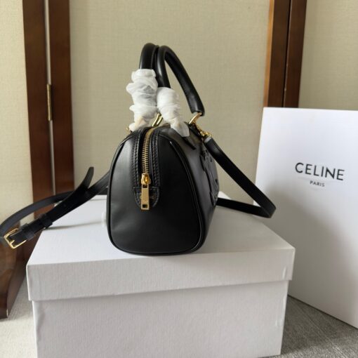 CELINE Small Boston Cuir Triomphe. Style meets sophistication with this timeless Celine Bag. The Celine Small Boston Cuir Triomphe is a classic accessory that is perfect for both day and night. It is made out of smooth calfskin leather with a stitched monogram pattern that creates an elegant, modern look. The bag features a removable and adjustable shoulder strap, a top handle for carrying, and a zipped closure. It also has a main spacious compartment, and one inner flat pocket. It has a small and compact size, perfect for days when you don't want to carry too much. The timeless design will never go out of style, and you'll be sure to feel confident and stylish with this bag on your arm. | CRIS AND COCO Authentic Quality Luxury Accessories