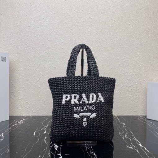 PRADA Small Crochet Tote Bag. Elevate Your Look with an Exquisite Tote Bag! This exquisite tote bag has a deconstructed design made of a light, natural material with a summery mood, raffia-effect yarn. Embroidered lettering logo decorates the front, and the emblematic triangle in enameled metal is the perfect finishing touch to the side. | CRIS&COCO Authentic Quality Designer Bags and Luxury Accessories