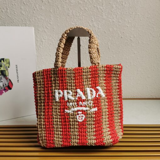 PRADA Small Crochet Tote Bag. Elevate Your Look with an Exquisite Tote Bag! This exquisite tote bag has a deconstructed design made of a light, natural material with a summery mood, raffia-effect yarn. Embroidered lettering logo decorates the front, and the emblematic triangle in enameled metal is the perfect finishing touch to the side. | CRIS&COCO Authentic Quality Designer Bags and Luxury Accessories