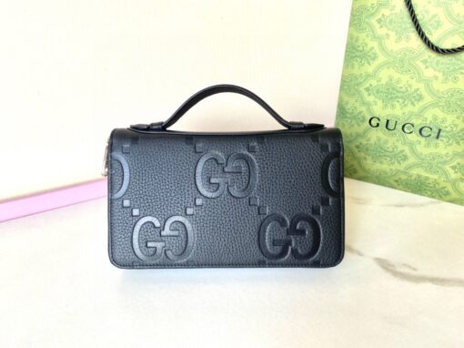 GUCCI Jumbo GG Travel Document Case. Embrace Timeless Luxury: Secure Your Journey with Gucci's Iconic GG Document Case. The iconic GG design makes a comeback for Pre-Fall 2023, adorning a range of small leather items. Paying homage to Guccio Gucci's initials, this motif remains timeless for the brand, showcased prominently in a large size to create a striking logo effect. In this particular case, the emblematic leather defines a travel document holder, ensuring security with a zip closure. | CRIS&COCO Authentic Quality Designer Bags and Luxury Accessories