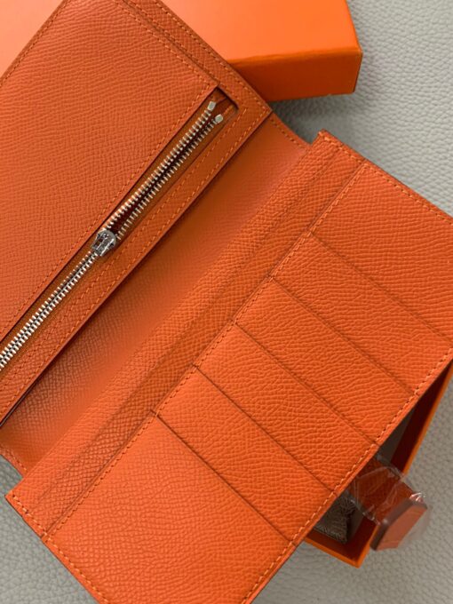 HERMÈS Béarn Wallet: Where Elegance Meets Functionality, Inspired by the Heart of France's South-West. The Béarn pays homage to the enchanting South-West region of France and stands as a distinguished member of a collection that honors various distinctive French regions. This wallet or card holder boasts an elegantly sleek design and is thoughtfully equipped with multiple compartments tailored for organizing credit cards, coins, and bills with ease. Upon closure, a supple leather flap gracefully glides into an iconic "H" shaped clasp, elevating it to a timeless classic. It presents a generous array of leather types and colors, allowing one to harmonize effortlessly with the latest trends in style. | CRIS&COCO Authentic Quality Designer Bags and Luxury Accessories