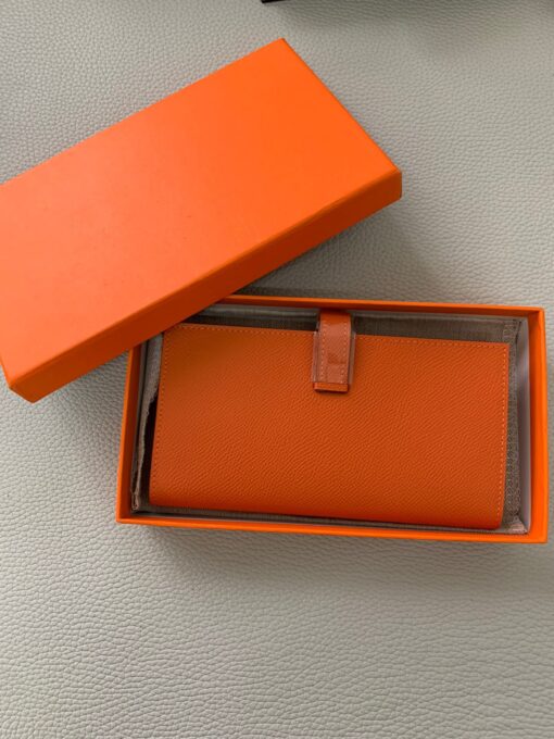 HERMÈS Béarn Wallet: Where Elegance Meets Functionality, Inspired by the Heart of France's South-West. The Béarn pays homage to the enchanting South-West region of France and stands as a distinguished member of a collection that honors various distinctive French regions. This wallet or card holder boasts an elegantly sleek design and is thoughtfully equipped with multiple compartments tailored for organizing credit cards, coins, and bills with ease. Upon closure, a supple leather flap gracefully glides into an iconic "H" shaped clasp, elevating it to a timeless classic. It presents a generous array of leather types and colors, allowing one to harmonize effortlessly with the latest trends in style. | CRIS&COCO Authentic Quality Designer Bags and Luxury Accessories