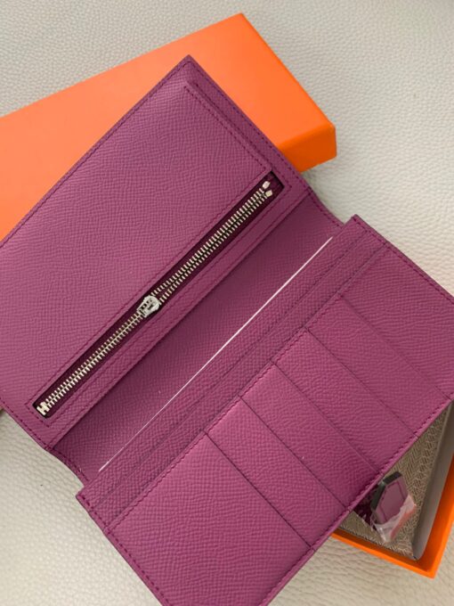 HERMÈS Béarn Wallet: Where Elegance Meets Functionality, Inspired by the Heart of France's South-West. The Béarn pays homage to the enchanting South-West region of France and stands as a distinguished member of a collection that honors various distinctive French regions. This wallet or card holder boasts an elegantly sleek design and is thoughtfully equipped with multiple compartments tailored for organizing credit cards, coins, and bills with ease. Upon closure, a supple leather flap gracefully glides into an iconic "H" shaped clasp, elevating it to a timeless classic. It presents a generous array of leather types and colors, allowing one to harmonize effortlessly with the latest trends in style. | CRIS&COCO Authentic Quality Designer Bags and Luxury Accessories