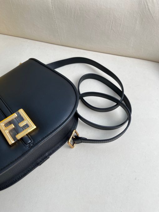 FENDI C’mon Medium. Timeless Elegance, Embodied in Leather. Elegantly designed, this medium-sized satchel bag boasts graceful, curved lines that exude femininity. Its elongated flap is adorned with a striking metal FF logo, adding a touch of sophistication to its overall charm. Crafted from supple leather with meticulously embossed edges and intricate details, this bag radiates a sense of refined luxury. The sides of the bag seamlessly blend with the overall design, crafted from the same tone-on-tone full-grain leather, ensuring a harmonious and visually pleasing aesthetic.