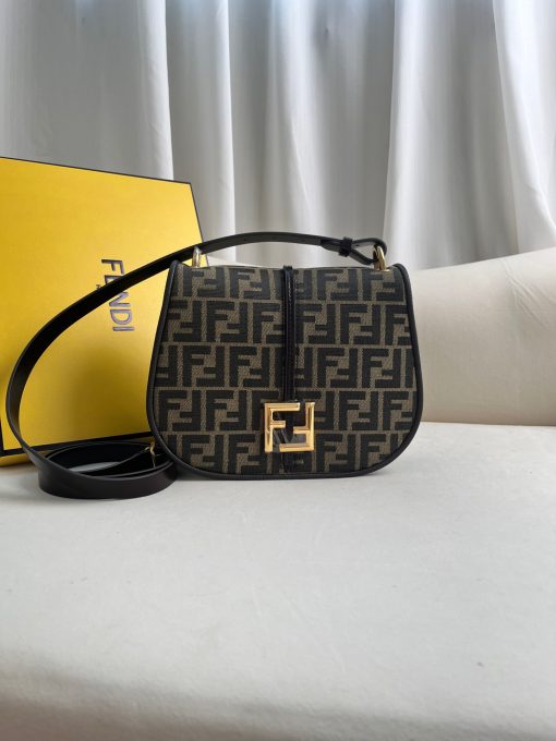 FENDI C’mon Medium. Timeless Elegance, Embodied in Leather. Elegantly designed, this medium-sized satchel bag boasts graceful, curved lines that exude femininity. Its elongated flap is adorned with a striking metal FF logo, adding a touch of sophistication to its overall charm. Crafted from supple leather with meticulously embossed edges and intricate details, this bag radiates a sense of refined luxury. The sides of the bag seamlessly blend with the overall design, crafted from the same tone-on-tone full-grain leather, ensuring a harmonious and visually pleasing aesthetic.