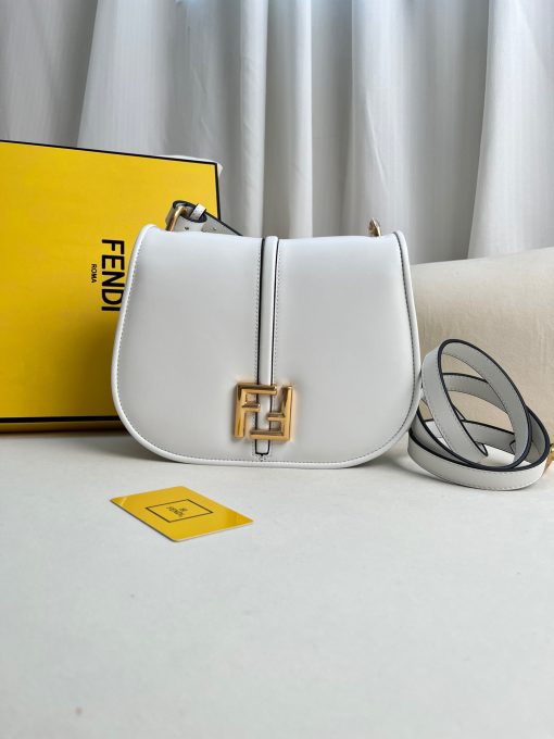 FENDI C’mon Medium. Timeless Elegance, Embodied in Leather. Elegantly designed, this medium-sized satchel bag boasts graceful, curved lines that exude femininity. Its elongated flap is adorned with a striking metal FF logo, adding a touch of sophistication to its overall charm. Crafted from supple leather with meticulously embossed edges and intricate details, this bag radiates a sense of refined luxury. The sides of the bag seamlessly blend with the overall design, crafted from the same tone-on-tone full-grain leather, ensuring a harmonious and visually pleasing aesthetic.