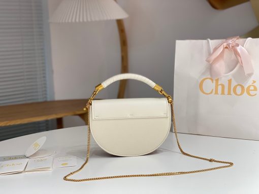 CHLOÉ Marcie Chain Flap Bag. Elevating Iconic Elegance: Marcie Line Redefined. Experience a fresh take on Chloé's iconic Marcie line with this exquisite chain flap bag, meticulously crafted from a captivating blend of nappa lambskin, grained calfskin, and sumptuous suede. The line's signature hardware undergoes a graceful transformation, now adorned with Chloé's engraved jewelry hallmark, adorning the flap with sophistication. An intricately hand-braided top handle pays homage to another hallmark Marcie feature, while a gracefully extended chain strap adds a refined touch. Whether you choose to drape it over your shoulder or wear it cross-body during the day, or opt to detach the strap and carry it by hand for a sophisticated evening ensemble, this flap bag is a versatile masterpiece. Chloé's Marcie bag line effortlessly melds a feminine aesthetic with the free-spirited vibe of the '70s. An equestrian-inspired allure takes center stage, elevated by the allure of gleaming gold-toned hardware, resulting in a distinctly feminine yet timelessly chic look.