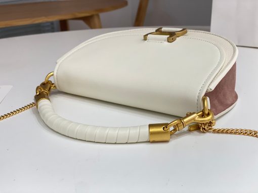 CHLOÉ Marcie Chain Flap Bag. Elevating Iconic Elegance: Marcie Line Redefined. Experience a fresh take on Chloé's iconic Marcie line with this exquisite chain flap bag, meticulously crafted from a captivating blend of nappa lambskin, grained calfskin, and sumptuous suede. The line's signature hardware undergoes a graceful transformation, now adorned with Chloé's engraved jewelry hallmark, adorning the flap with sophistication. An intricately hand-braided top handle pays homage to another hallmark Marcie feature, while a gracefully extended chain strap adds a refined touch. Whether you choose to drape it over your shoulder or wear it cross-body during the day, or opt to detach the strap and carry it by hand for a sophisticated evening ensemble, this flap bag is a versatile masterpiece. Chloé's Marcie bag line effortlessly melds a feminine aesthetic with the free-spirited vibe of the '70s. An equestrian-inspired allure takes center stage, elevated by the allure of gleaming gold-toned hardware, resulting in a distinctly feminine yet timelessly chic look.