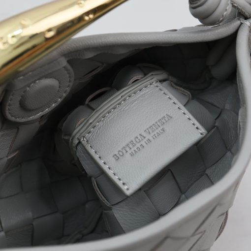 BOTTEGA VENETA Mini Sardine. Crafted to Perfection, Inspired by Nature: Your Timeless Companion for All Occasions. BOTTEGA VENETA's masterful intrecciato weaving technique was originally crafted to ensure the enduring quality of leather goods. The Sardine Mini leather shoulder bag, meticulously fashioned from supple lamb leather, showcases a distinctive top handle reminiscent of a graceful fish. This versatile piece seamlessly transitions from day to night, making it the perfect, reliable companion to elegantly accommodate all your essentials.