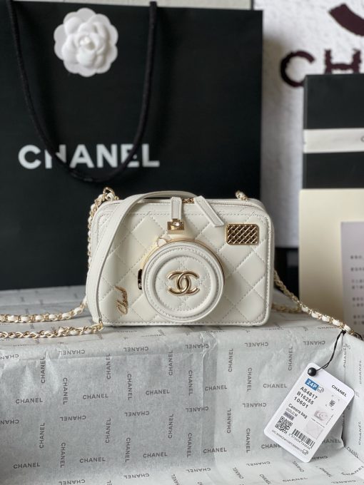 CHANEL Camera Bag. A pinnacle of timeless elegance and contemporary sophistication. This iconic piece showcases exquisite craftsmanship and meticulous attention to detail. The camera bag design exudes versatility and style, offering a modern reinterpretation of a classic silhouette. Made from premium materials, it boasts buttery-soft lambskin leather, adorned with the iconic quilted pattern synonymous with CHANEL's heritage. With its compact yet spacious interior, the Camera Bag effortlessly accommodates all your essentials while maintaining a sleek and streamlined profile. The signature Chanel interlocking CC logo adorns the front, adding a touch of unmistakable luxury to the design.